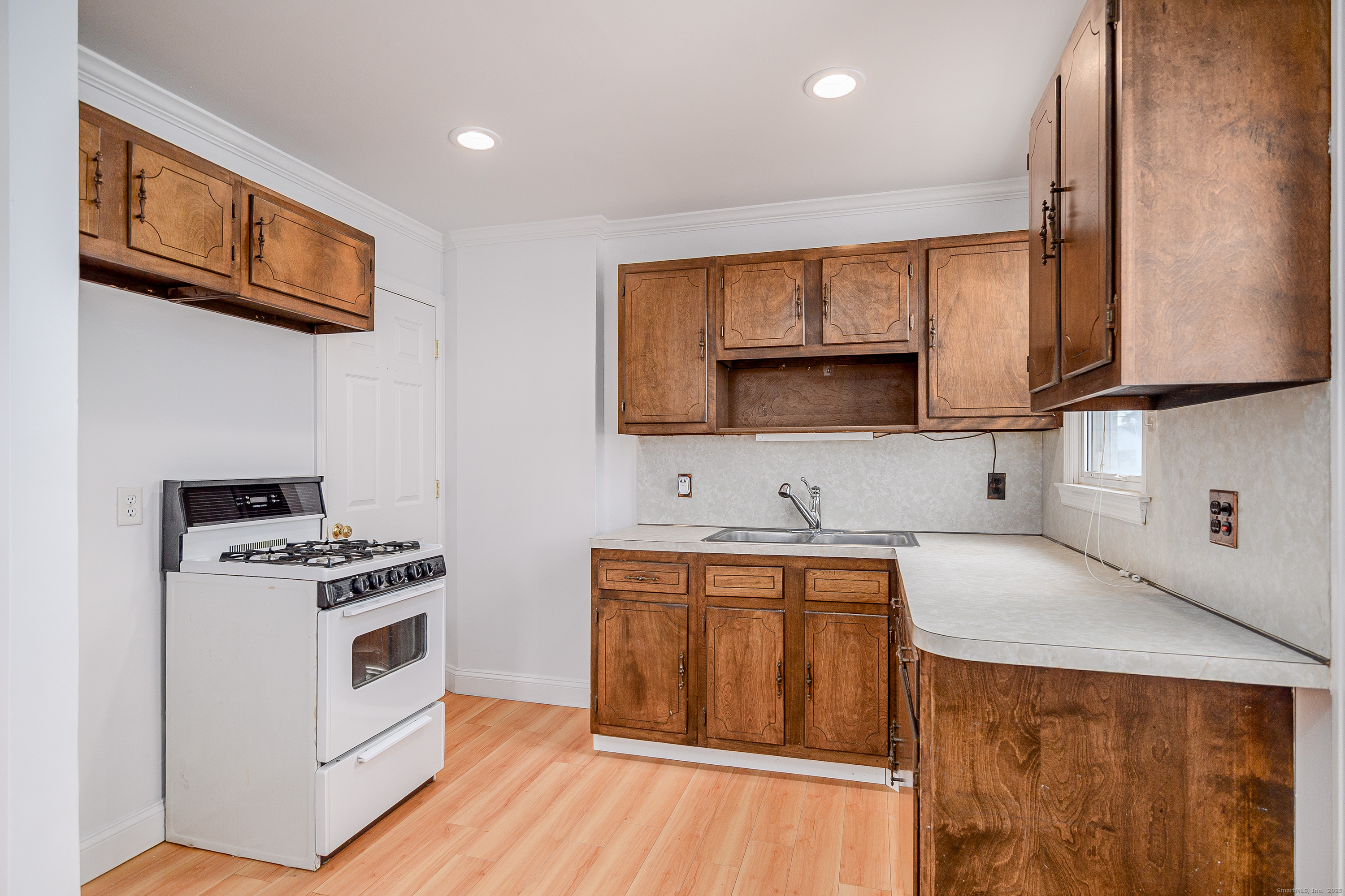 114 Sylvan Knoll Road Stamford, CT 06902 - Photo 8 of 23 a kitchen with stainless steel appliances a stove a sink and a microwave