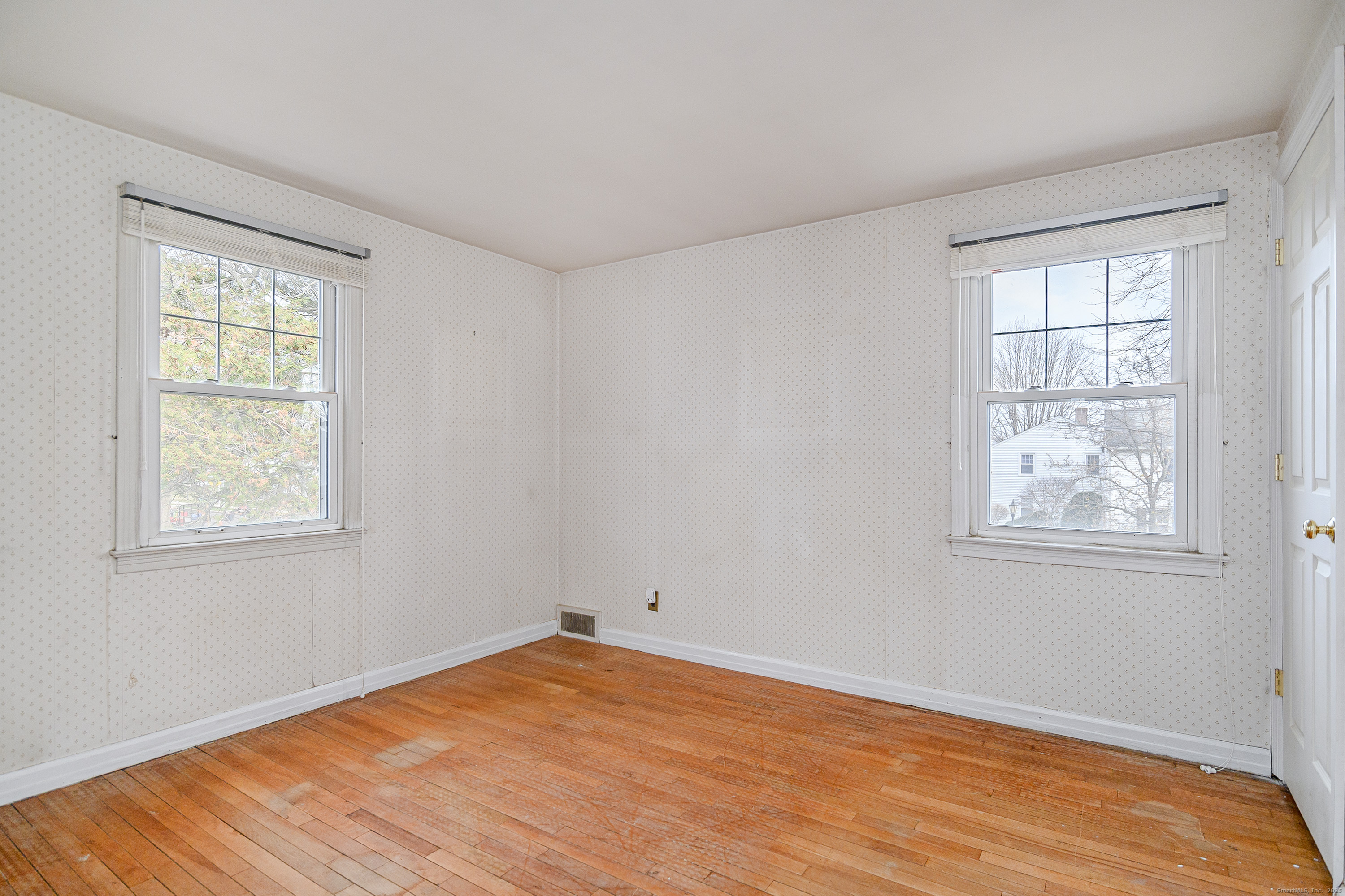 114 Sylvan Knoll Road Stamford, CT 06902 - Photo 9 of 23 an empty room with wooden floor and windows
