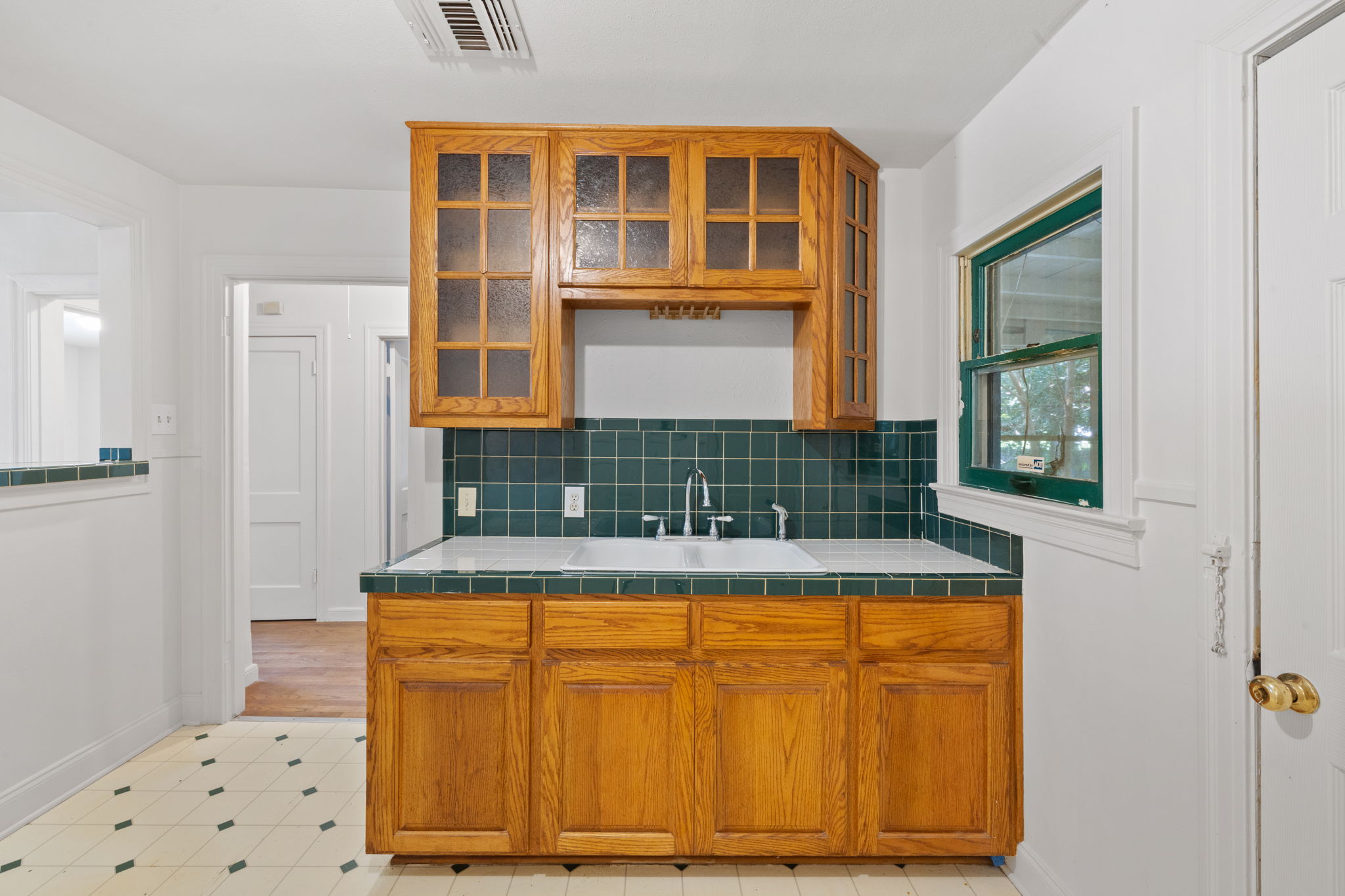 3704 Cherrywood Road Austin, TX 78722 - Photo 14 of 40 Nice cabinets with tile countertops and backsplash.
