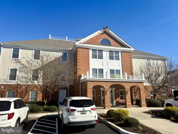 a front view of a house with cars