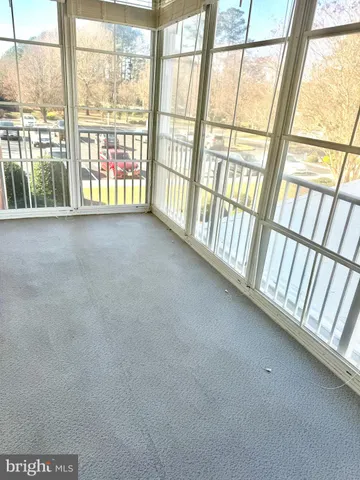 a view of an empty room with a floor to ceiling window