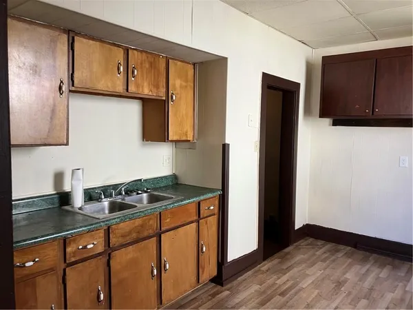 a kitchen with granite countertop cabinets and window