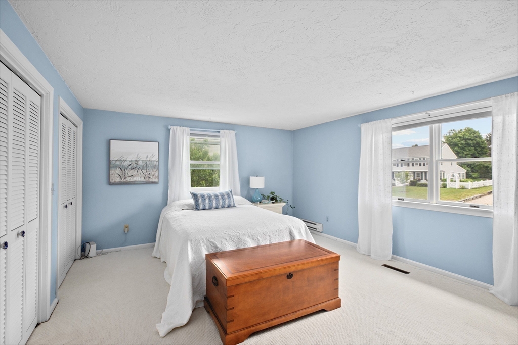 8 Cliff Estates Road, Unit 8 Scituate, MA 02066 - Photo 17 of 36 a room with a bed and a window
