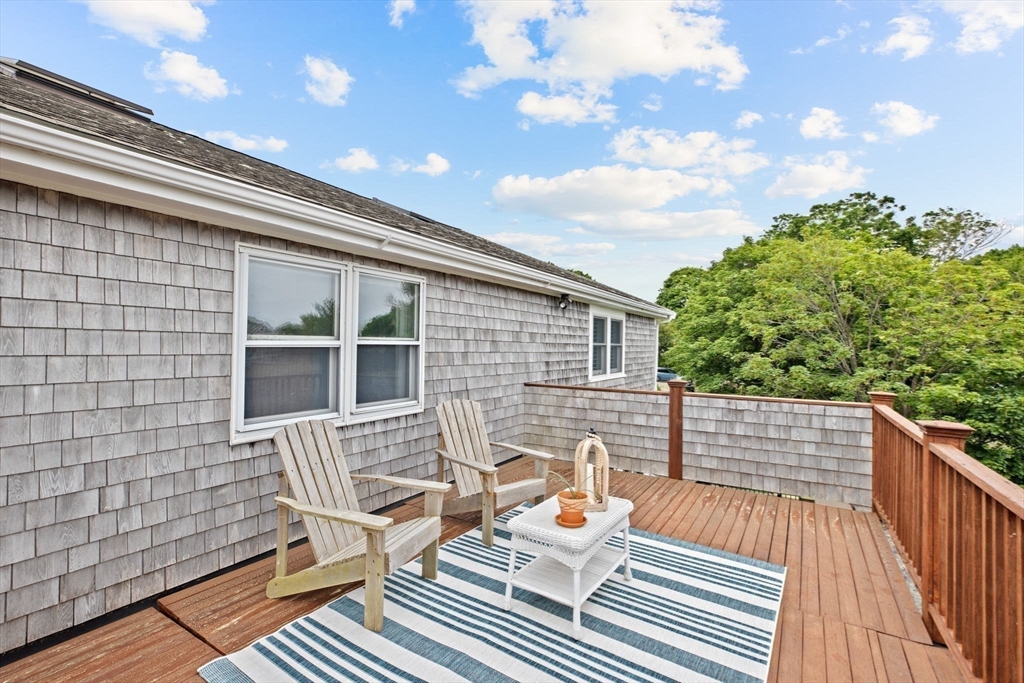 8 Cliff Estates Road, Unit 8 Scituate, MA 02066 - Photo 30 of 36 a view of deck with chairs and wooden floor