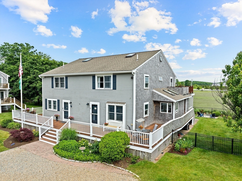 8 Cliff Estates Road, Unit 8 Scituate, MA 02066 - Photo 3 of 36 a front view of a house with a yard
