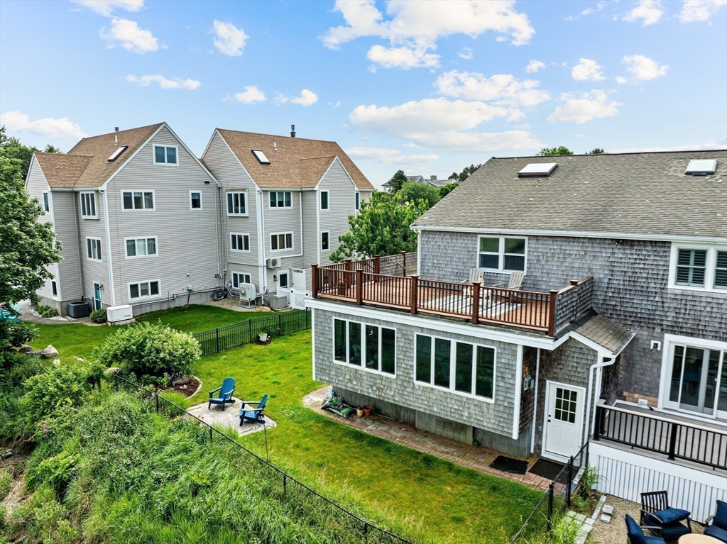 8 Cliff Estates Road, Unit 8 Scituate, MA 02066 - Photo 32 of 36 a view of a house with a yard deck and a garden