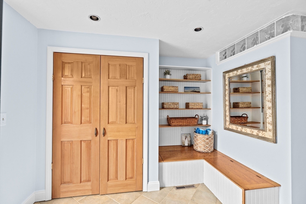 8 Cliff Estates Road, Unit 8 Scituate, MA 02066 - Photo 5 of 36 a view of a hallway with wooden floor and cabinet