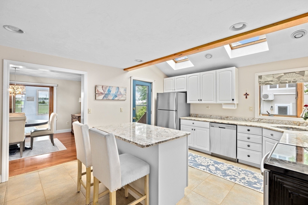 8 Cliff Estates Road, Unit 8 Scituate, MA 02066 - Photo 8 of 36 a large kitchen with granite countertop lots of white cabinets a sink and appliances