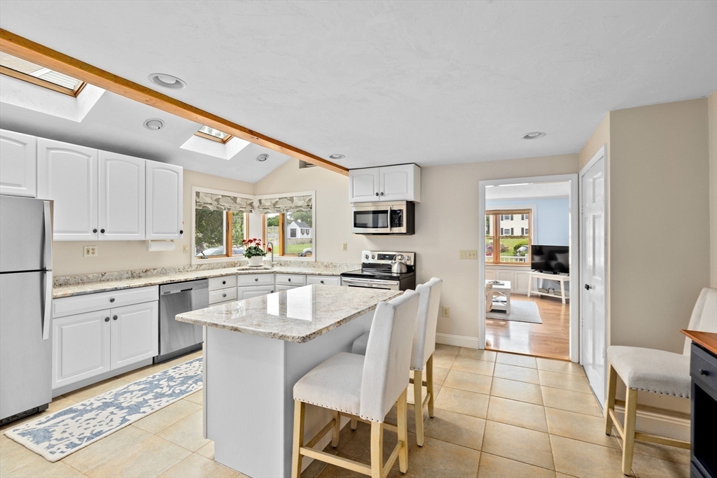 8 Cliff Estates Road, Unit 8 Scituate, MA 02066 - Photo 9 of 36 a large white kitchen with granite countertop lots of white cabinets a sink and dishwasher