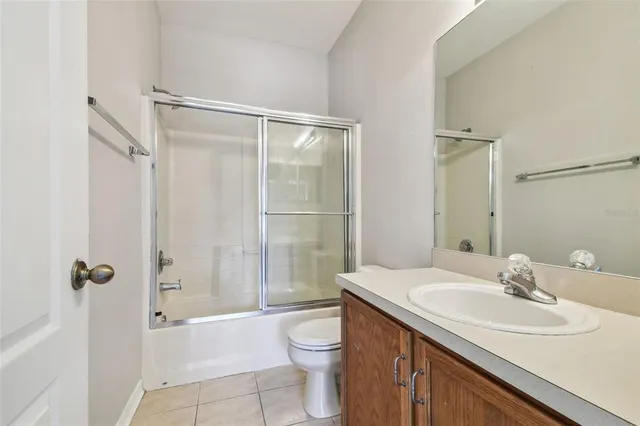 an empty room with a window and a ceiling fan