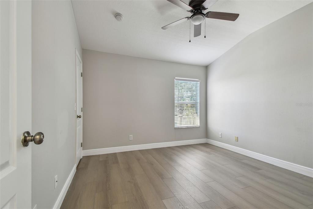 16227 Swan View Circle Odessa, FL 33556 - Photo 17 of 29 an empty room with a window and a ceiling fan