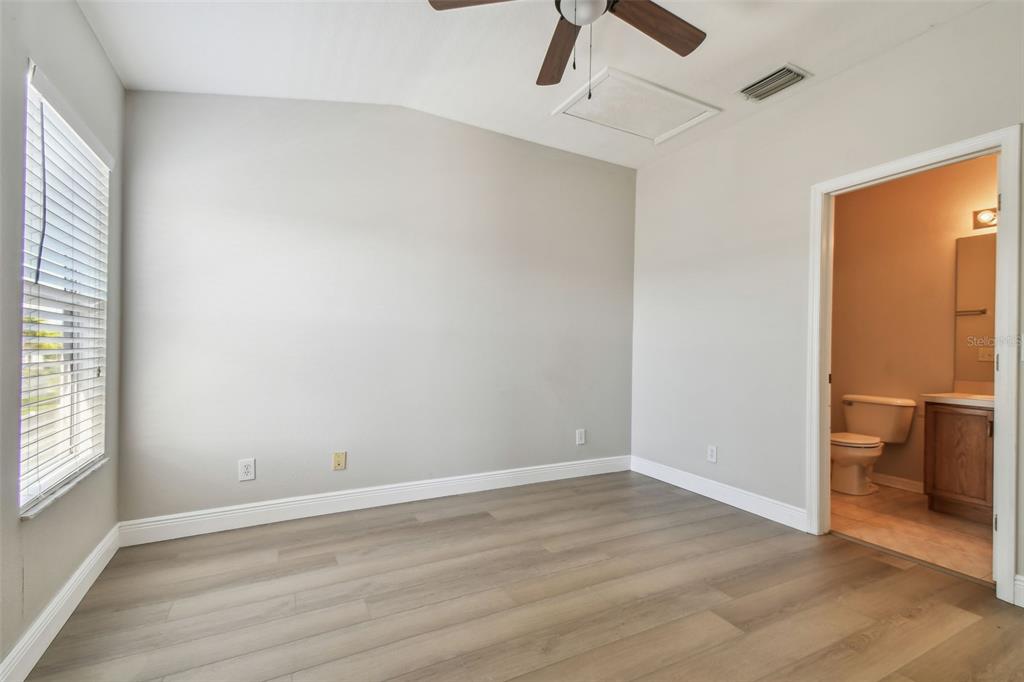 16227 Swan View Circle Odessa, FL 33556 - Photo 18 of 29 wooden floor in an empty room with a window