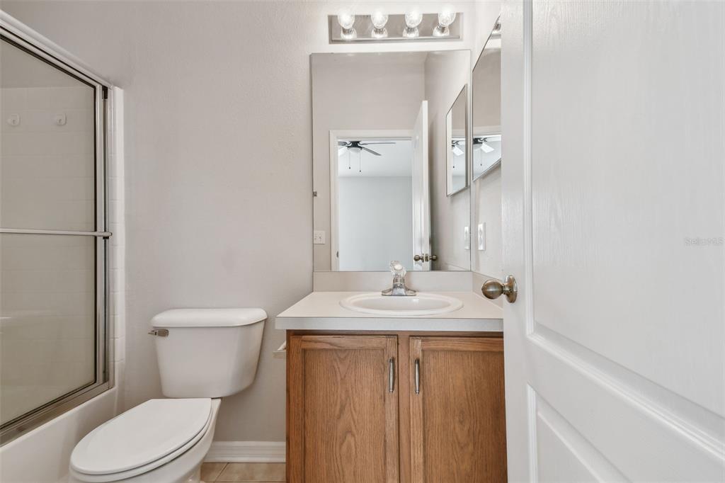 16227 Swan View Circle Odessa, FL 33556 - Photo 19 of 29 a bathroom with a granite countertop sink toilet and mirror