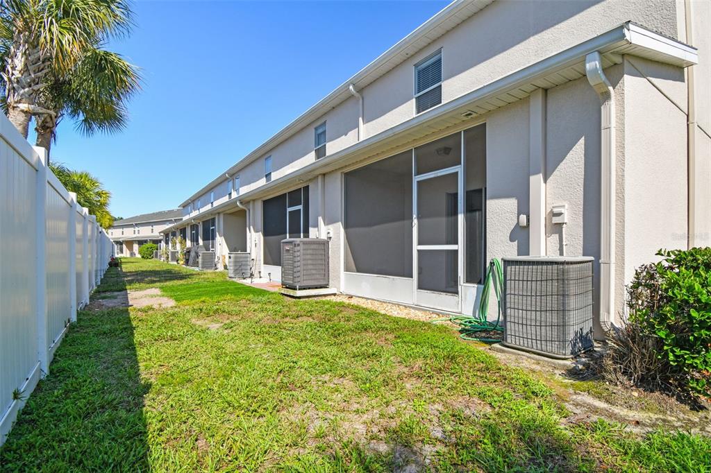 16227 Swan View Circle Odessa, FL 33556 - Photo 23 of 29 a view of a house with brick walls and a yard with plants