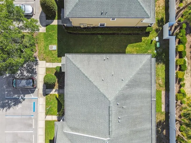 an aerial view of residential houses with outdoor space and river