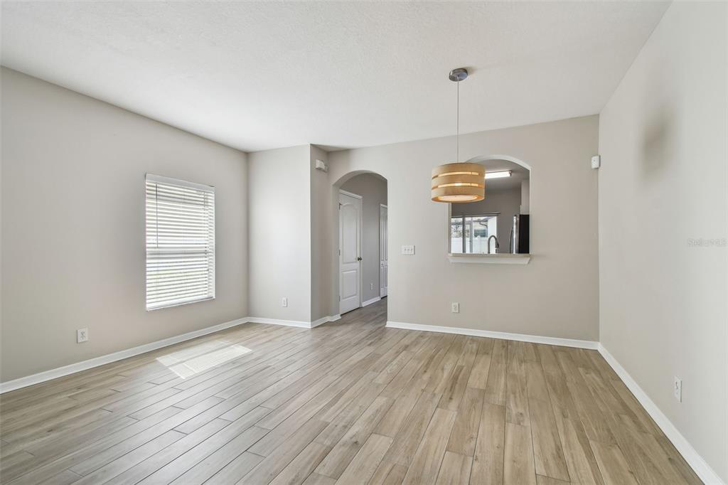 16227 Swan View Circle Odessa, FL 33556 - Photo 6 of 29 a view of an empty room with wooden floor and a window