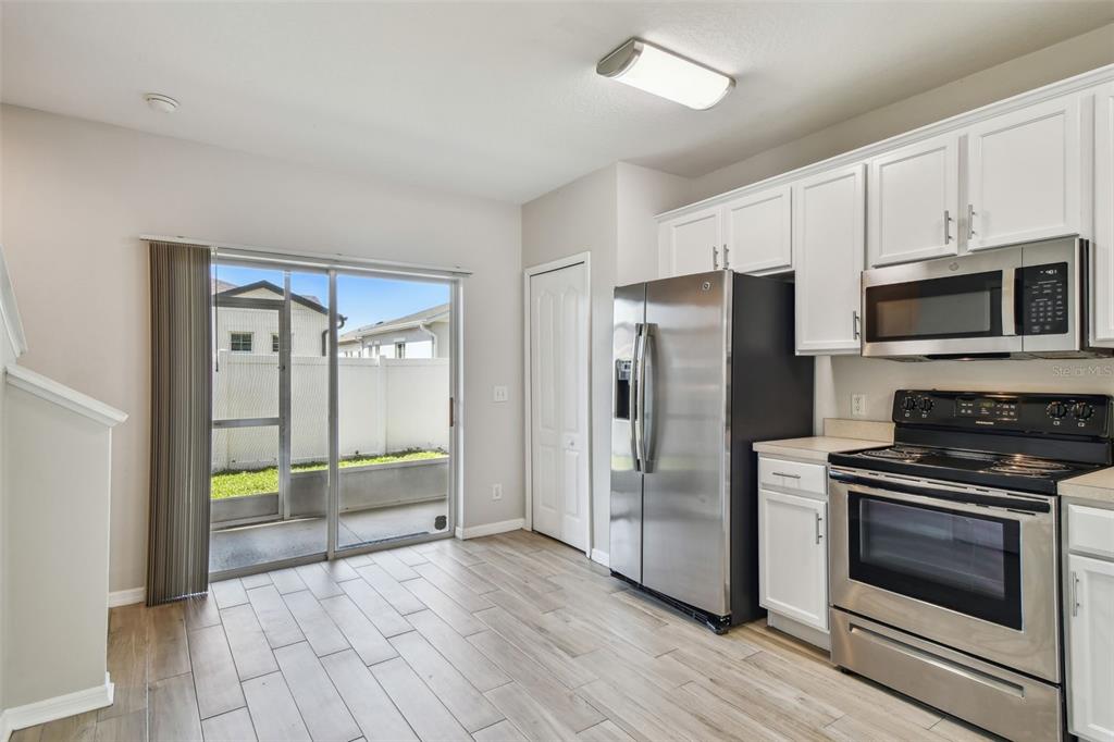 16227 Swan View Circle Odessa, FL 33556 - Photo 9 of 29 a kitchen with granite countertop a refrigerator and a stove top oven