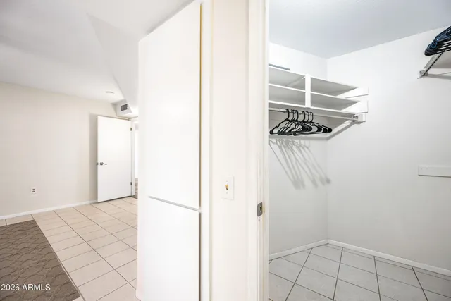 a view of walk in closet with empty racks