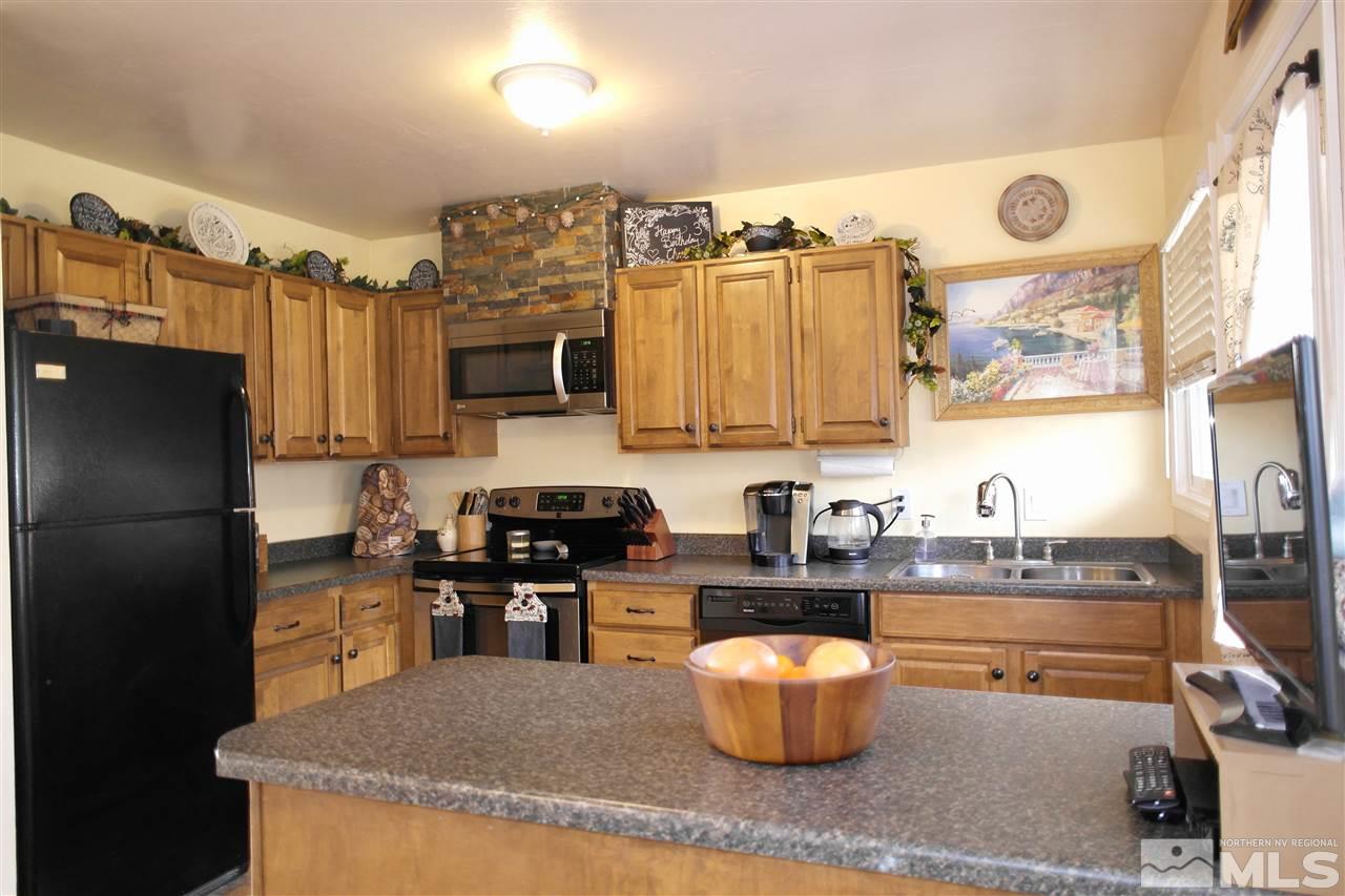 1345 Peavine Road Reno, NV 89503 - Photo 6 of 25 a kitchen with stainless steel appliances granite countertop a stove a sink and a refrigerator