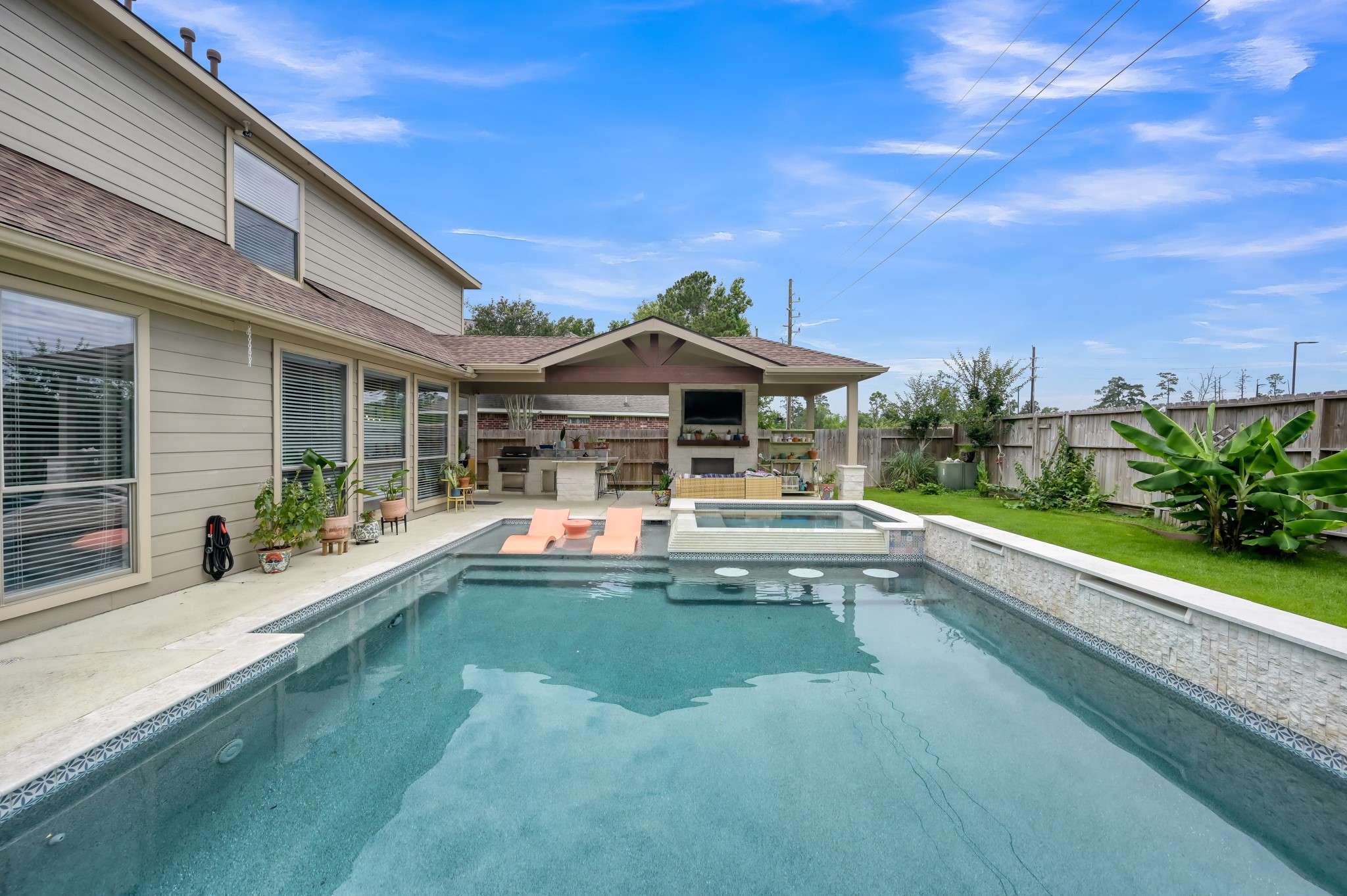 28522 Misty Cliff Lane Spring, TX 77386 - Photo 11 of 12 Resort-inspired backyard features sparkling pool, elevated spa, covered outdoor living pavilion, and outdoor kitchen. Exceptional space combines luxury amenities with functional everyday living.