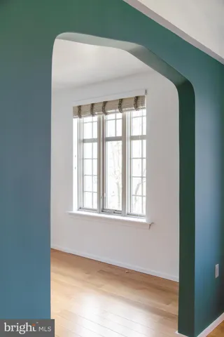 a large room with wooden floor and windows