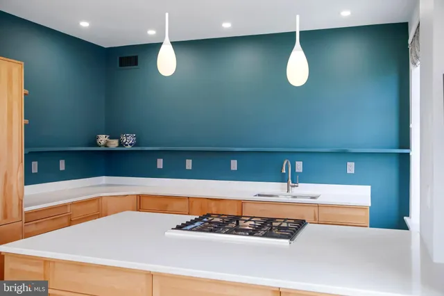 a view of a living room with a sink and cabinets
