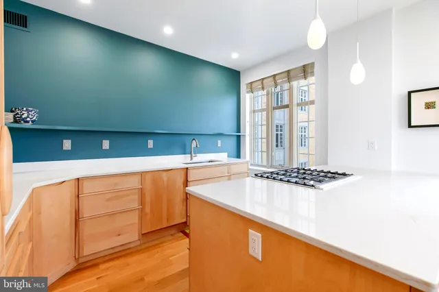 a kitchen with a refrigerator and a sink
