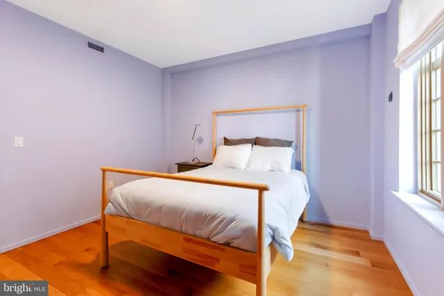 a bedroom with a bed and a table