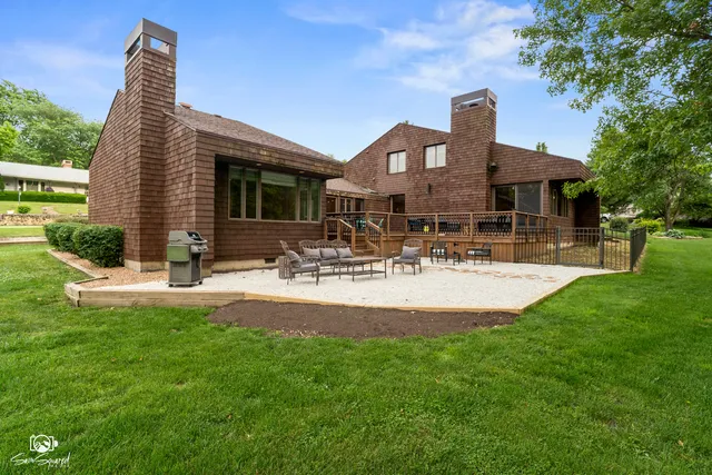 a front view of house with yard and outdoor seating