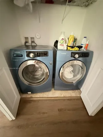 a utility room with two washing machine
