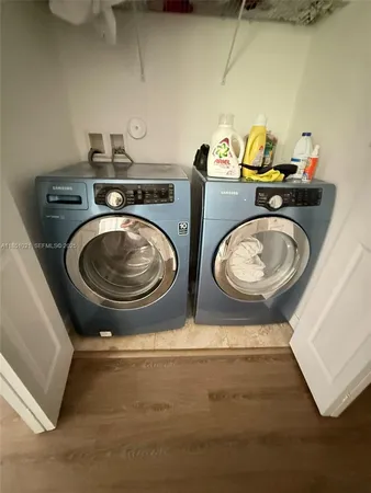 a utility room with two washing machine