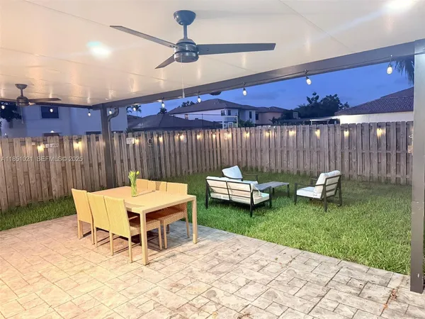 a view of a patio with a table and chairs