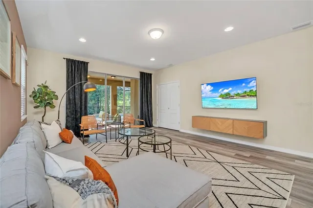 a living room with furniture tv and large window