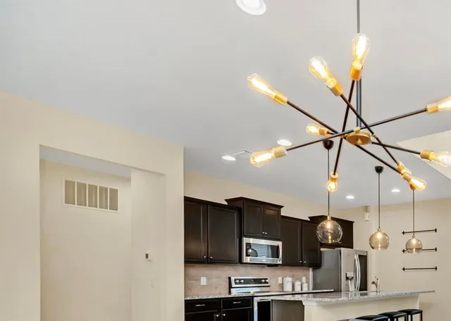 a kitchen with stainless steel appliances kitchen island a refrigerator and a microwave