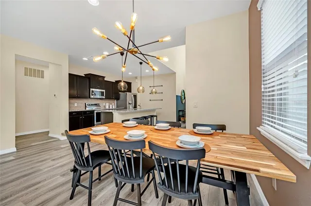 a view of a dining room with furniture and wooden floor