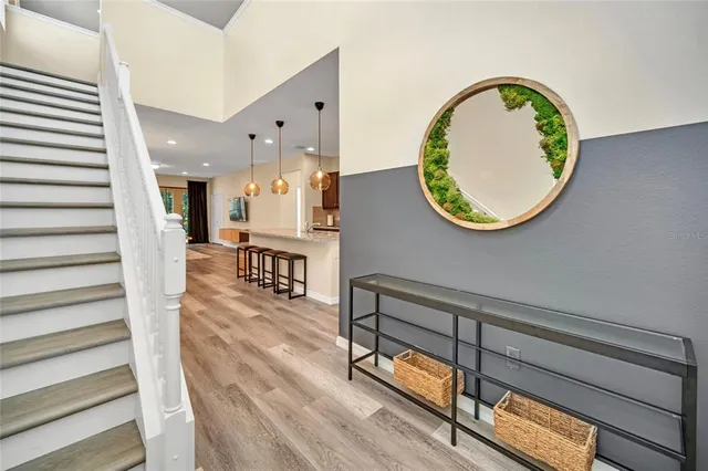 a view of a hallway with wooden floor and staircase