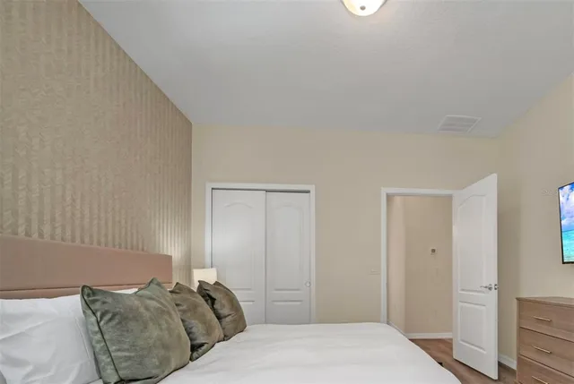 a bedroom with a bed and a window