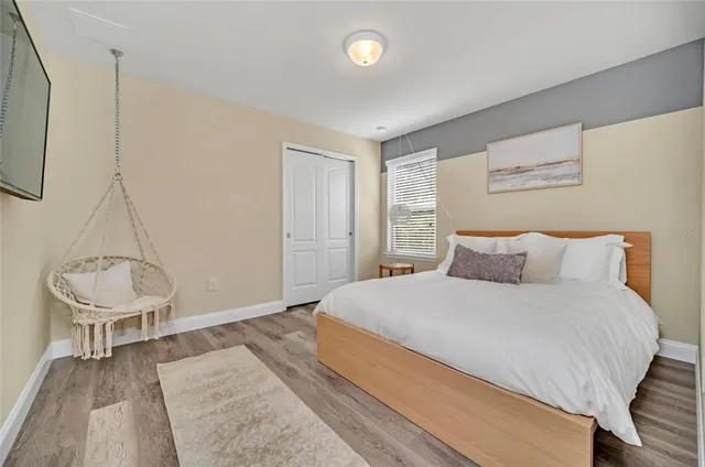 a bedroom with a bed and a chair