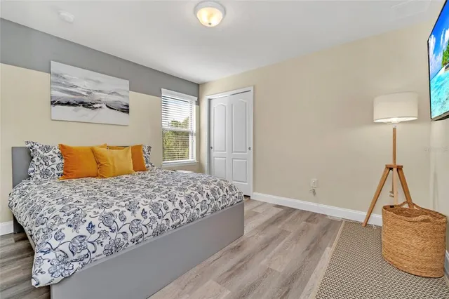 a bedroom with a bed and wooden floor