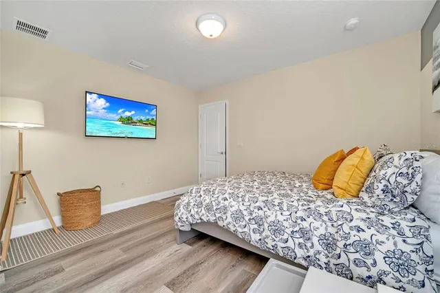 a bedroom with a bed and a large window