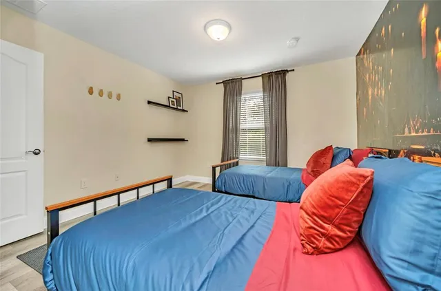 a bathroom with a granite countertop sink a mirror and a bathtub