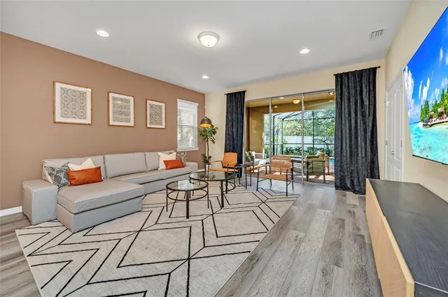a living room with furniture and a wooden floor