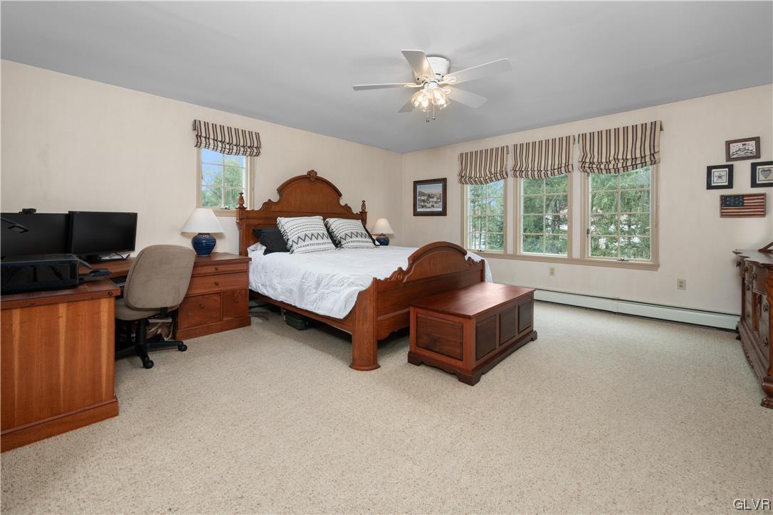 144 Devonshire Drive Stroudsburg, PA 18360 - Photo 25 of 34 a spacious bedroom with a bed and a chandelier