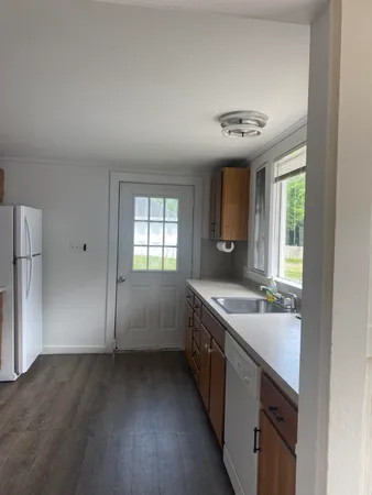 a spacious bathroom with a granite countertop sink a toilet and a mirror
