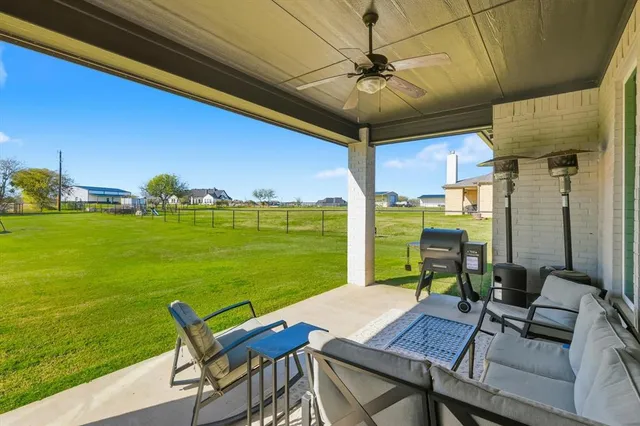 a view of a patio with a table chairs and a table
