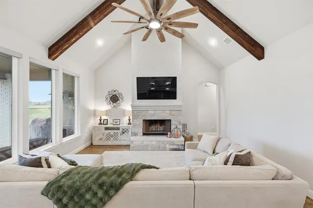 a living room with furniture a fireplace and a flat screen tv