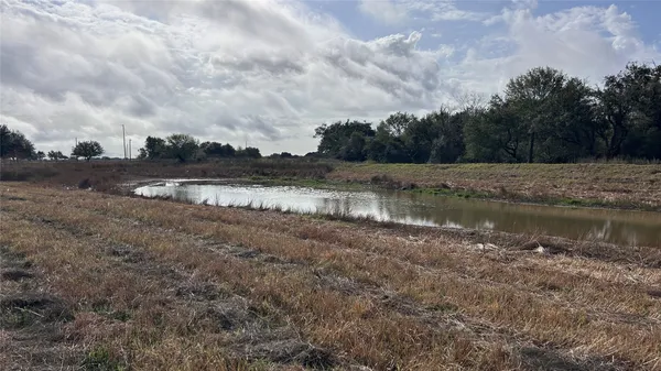 a view of a lake with houses in the back