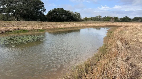 a sign board with yard in the back