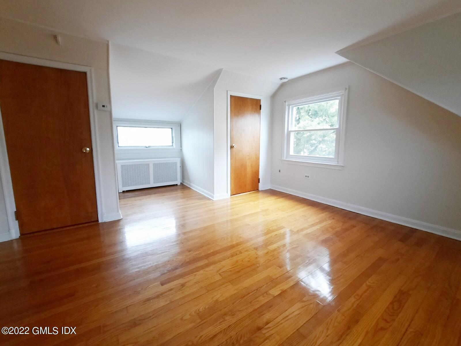 13 High Street Greenwich, CT 06830 - Photo 13 of 21 an empty room with wooden floor and windows