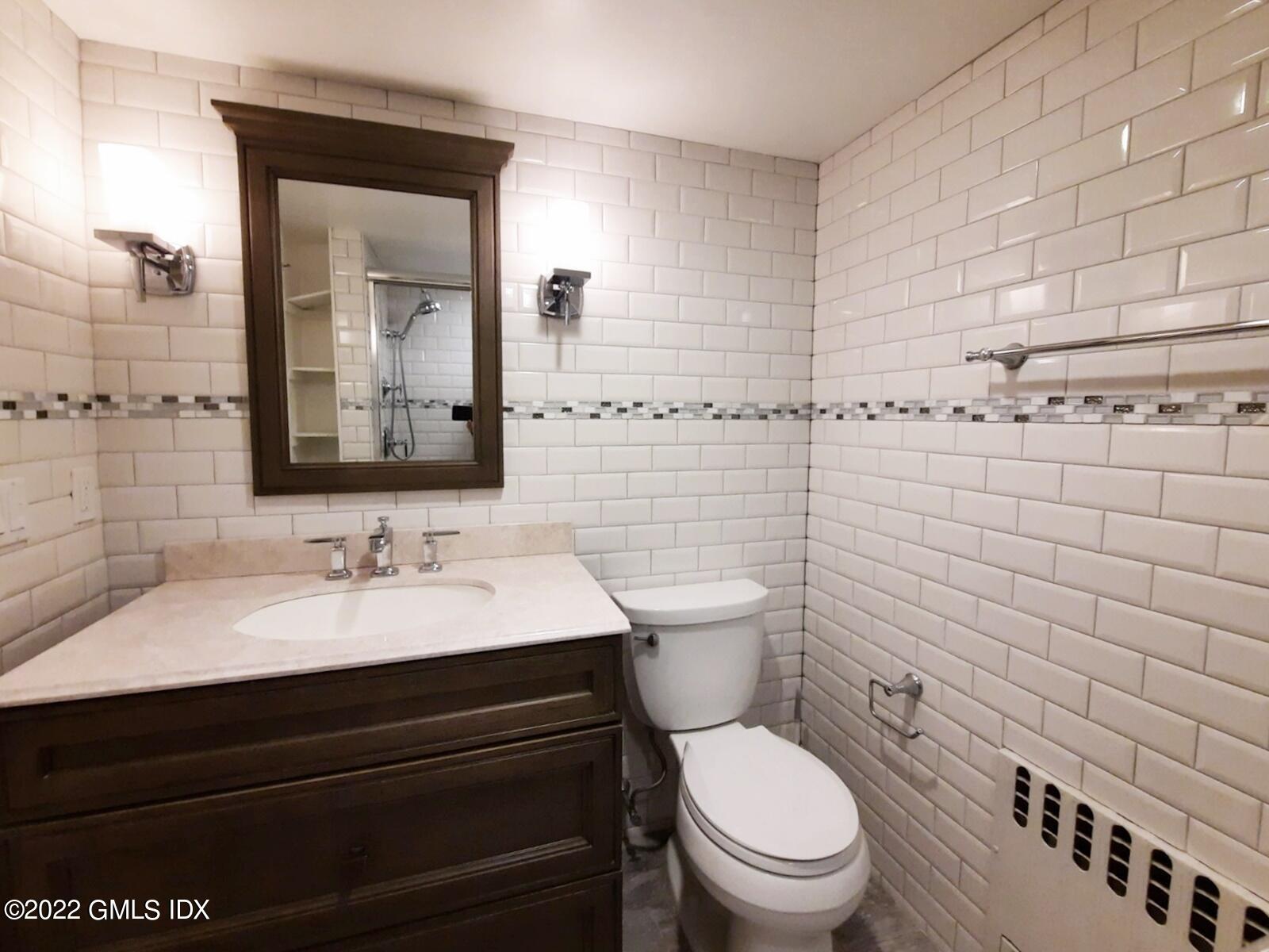 13 High Street Greenwich, CT 06830 - Photo 17 of 21 a bathroom with a toilet sink and mirror